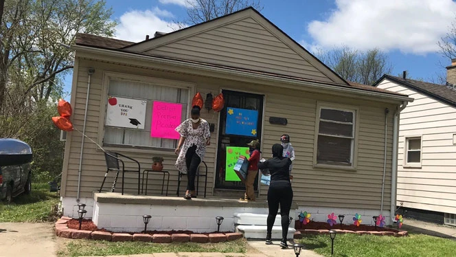 Detroit Premier staff visit a family
