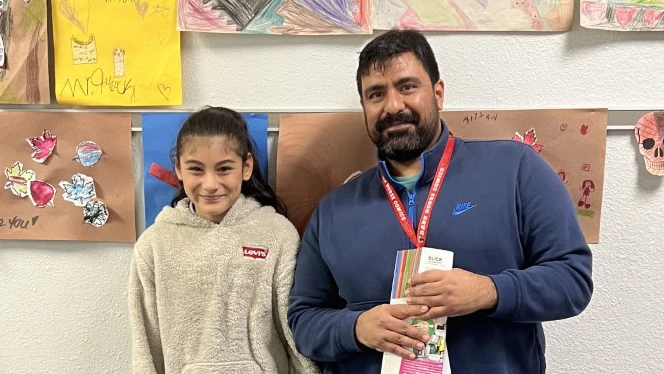 Estrella (Star) Torres standing with her K-8 Art Teacher Guillermo Embil. Estrella (Star) Torres standing with her K-8 Art Teacher Guillermo Embil.