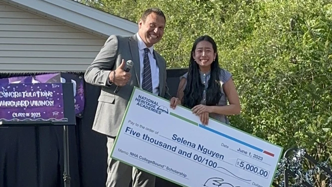 Selena Nguyen holding her scholarship.