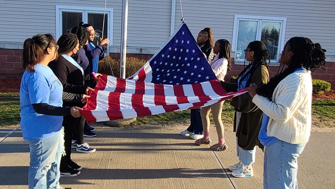 Students attaching the flag. Students attaching the flag.