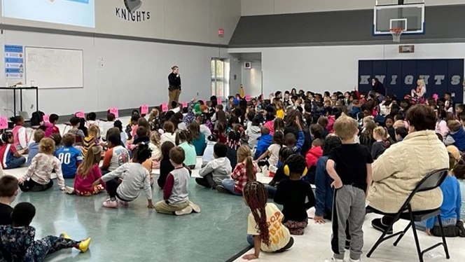 Students sitting at assembly.