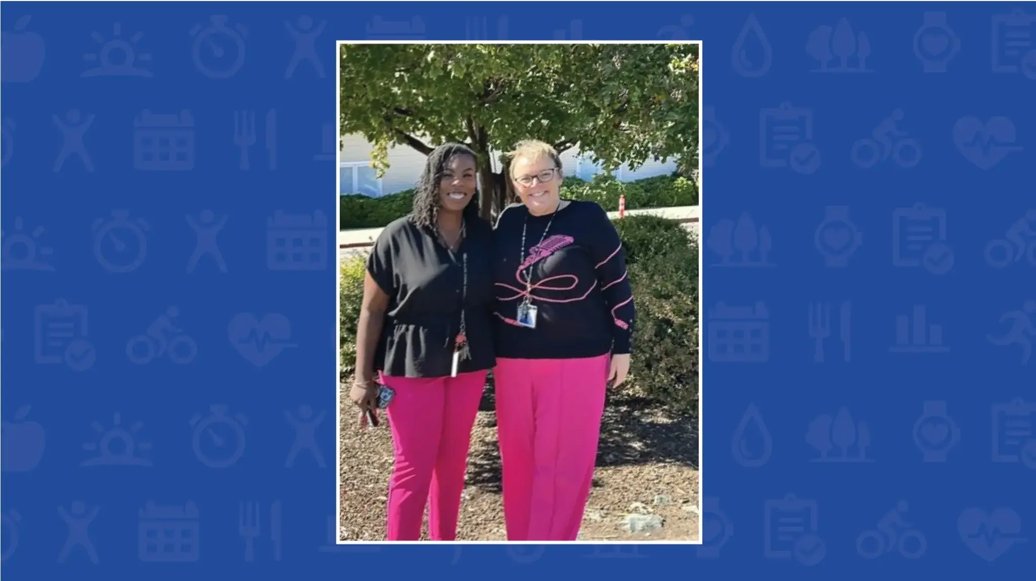 two women standing together smiling