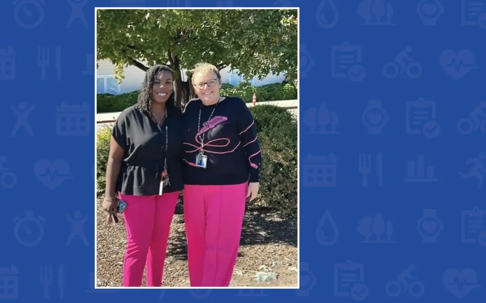 two women standing together smiling