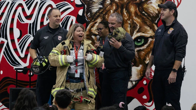 K-8 School in Canton: Canton Charter Principal puts on fireman's suit at Safe Schools Week assembly.