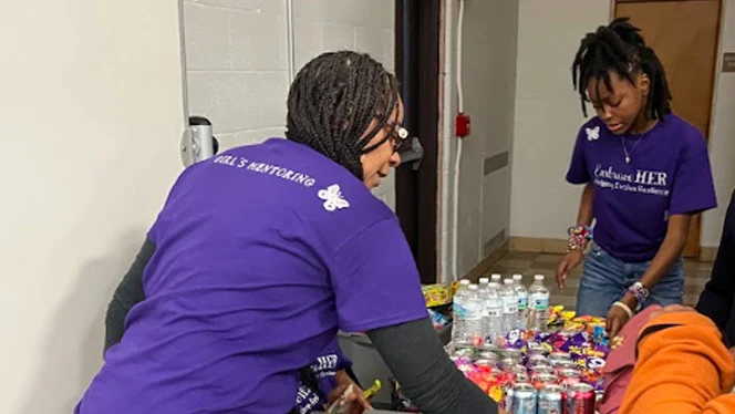 "Embrace HER" doing volunteer work.