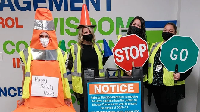 People holding up safety signs. People holding up safety signs.