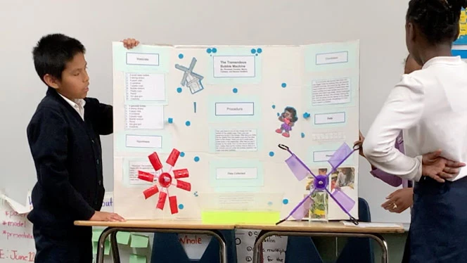 Students presenting their science project. Students presenting their science project.