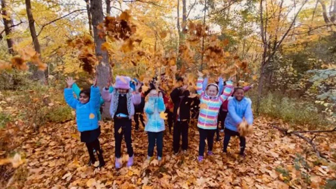 Students playing in the leaves.