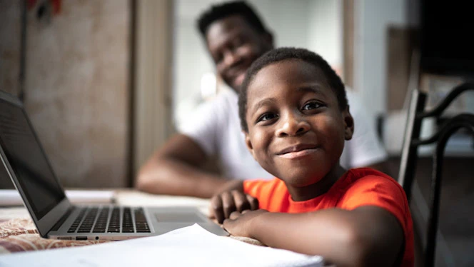 Child on a computer smiling. Child on a computer smiling.
