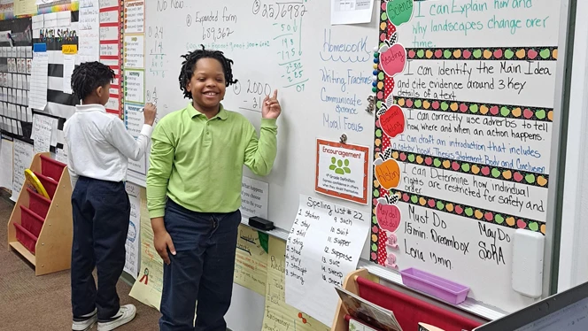Students at white board.