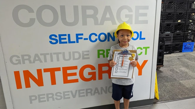 A child wearing a hard hat. A child wearing a hard hat.