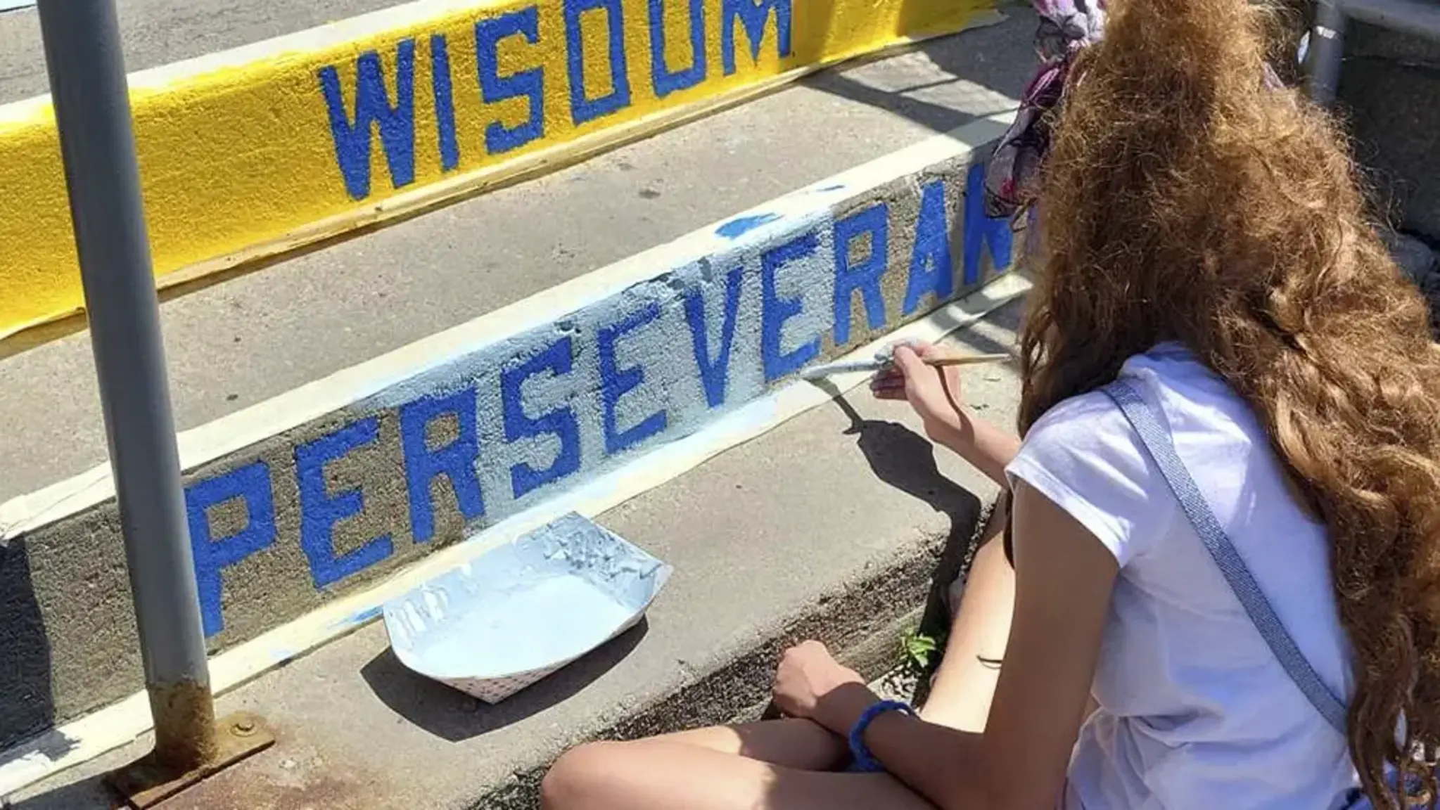 Apex Art Club Scholars Refresh Staircase with Familiar Words