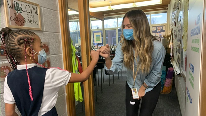 Teacher and student locking pinkies. Teacher and student locking pinkies.