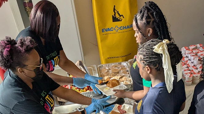 K-8 School in St. Albans: Riverton families help serve food to students before testing at Riverton Street Charter School.