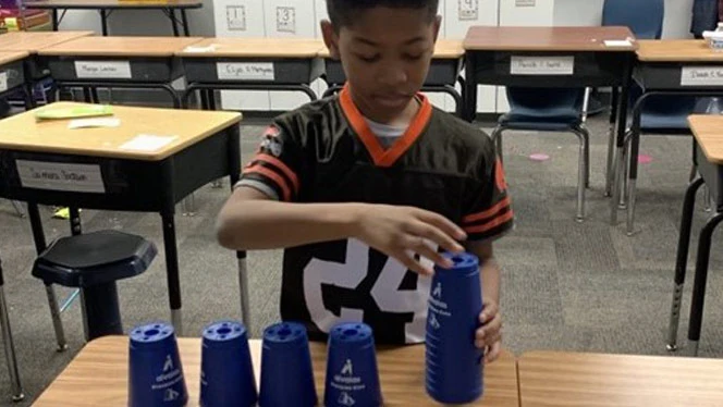 Student stacking cups