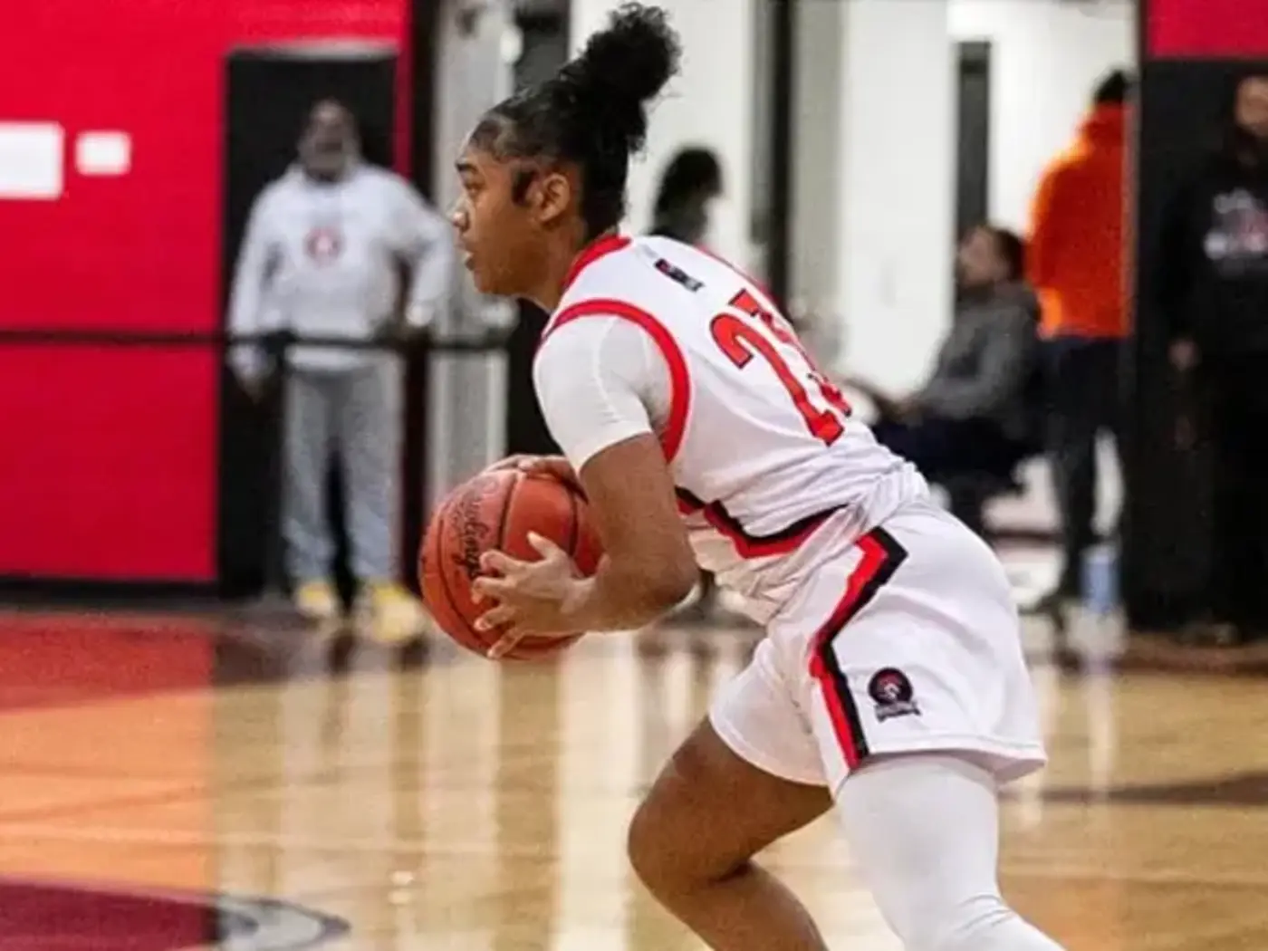 Teen girl playing basketball