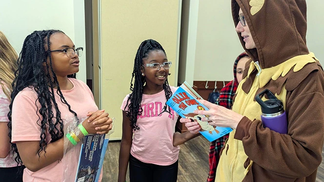 Charter School in Grand Rapids: NHA manager and author, reads her book to local NHA students.