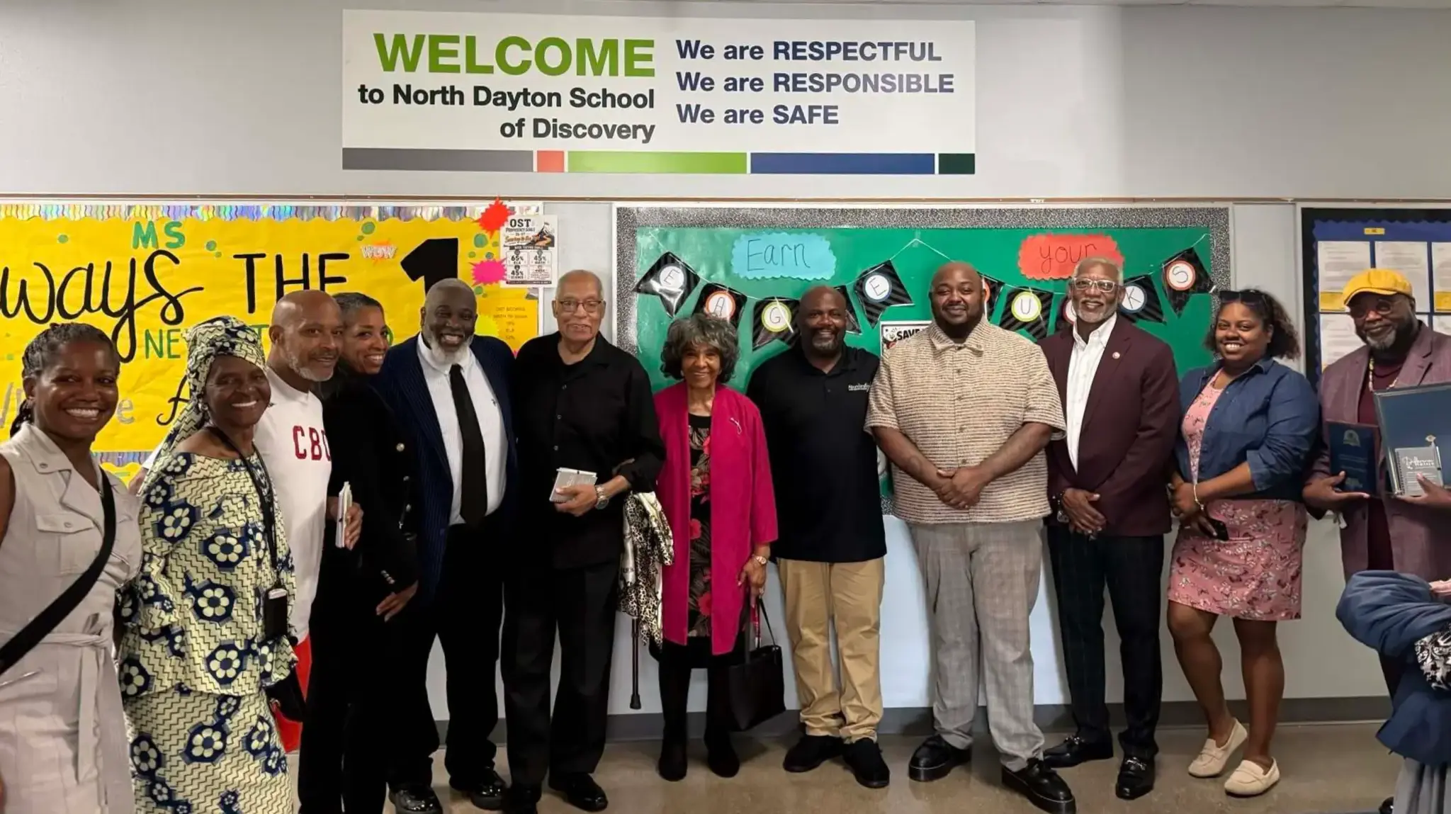 a group of people standing in front of a board