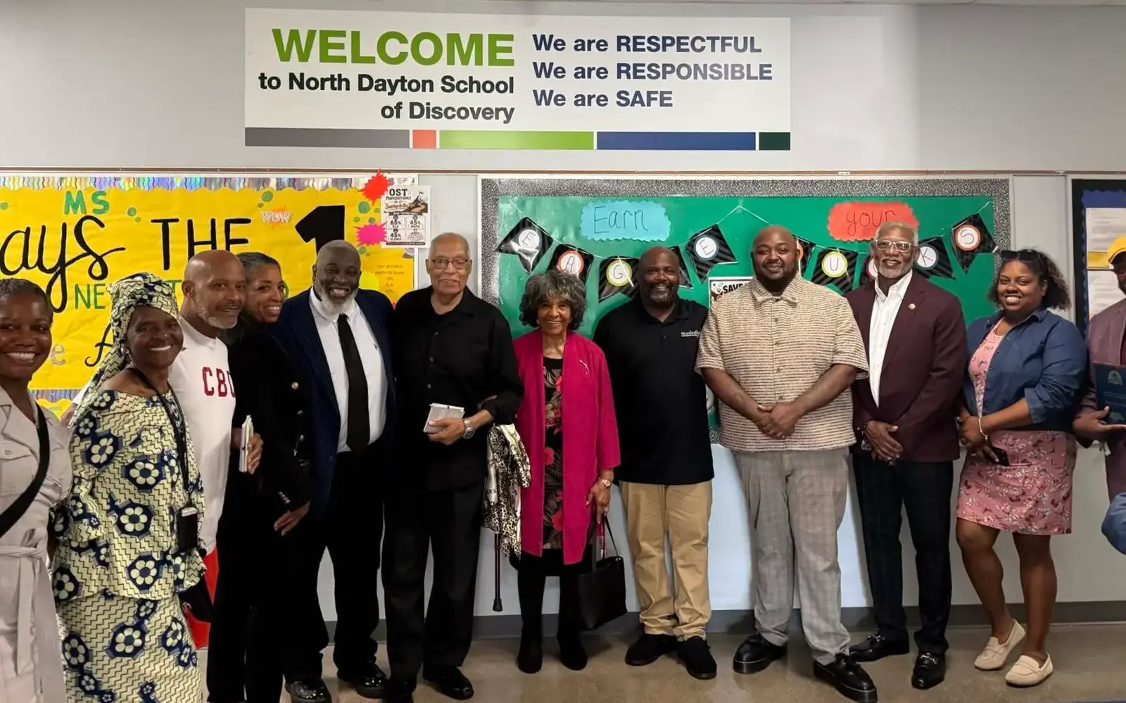 a group of people standing in front of a board