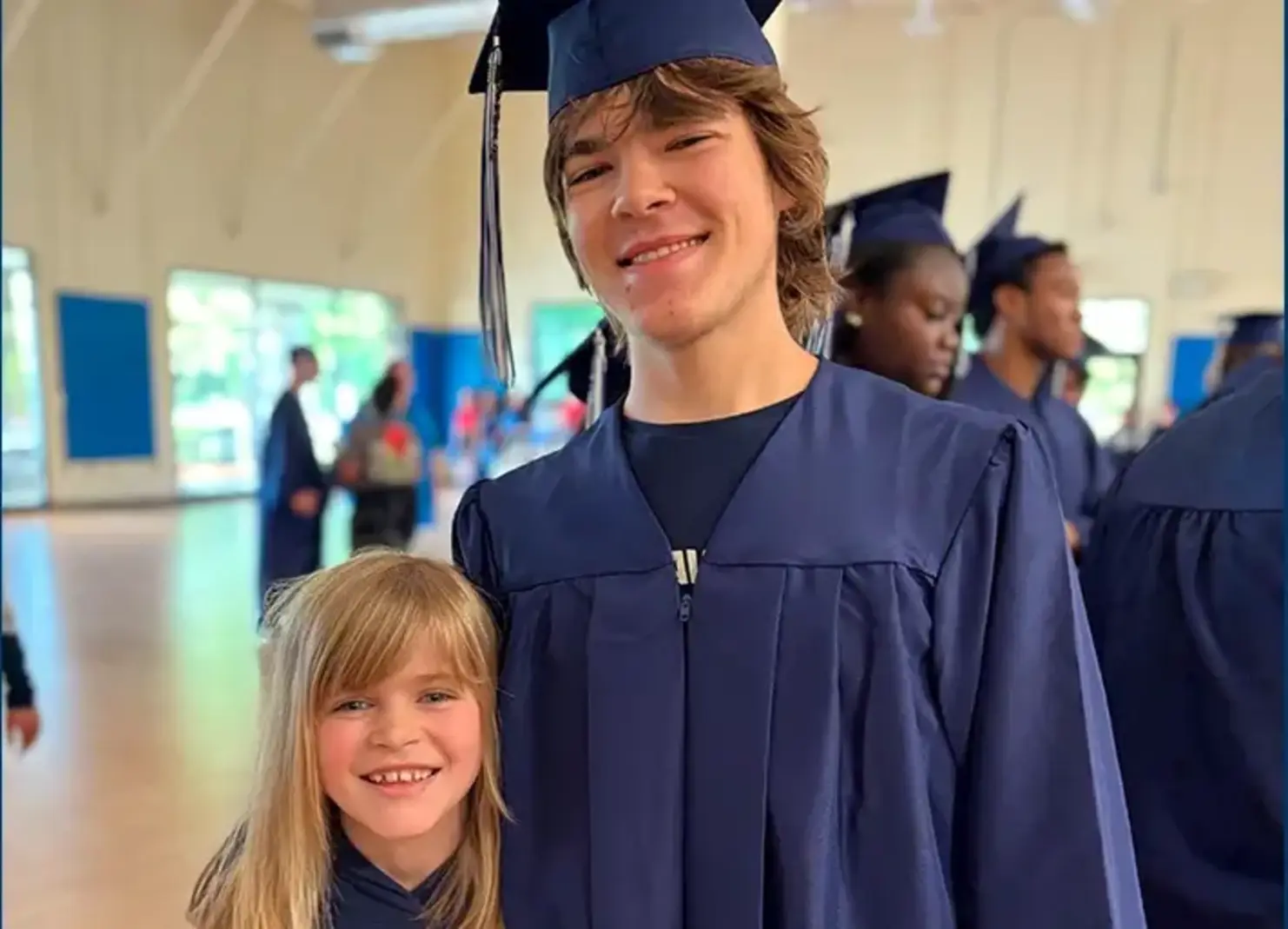High school grad with young student
