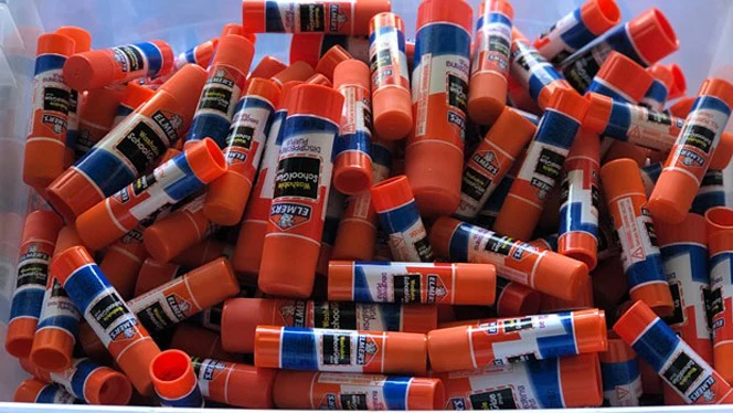 A box of glue sticks. A box of glue sticks.