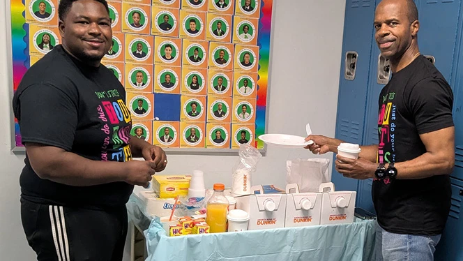 K-8 School in St. Albans: Riverton families help serve food to students before testing at Riverton Street Charter School.