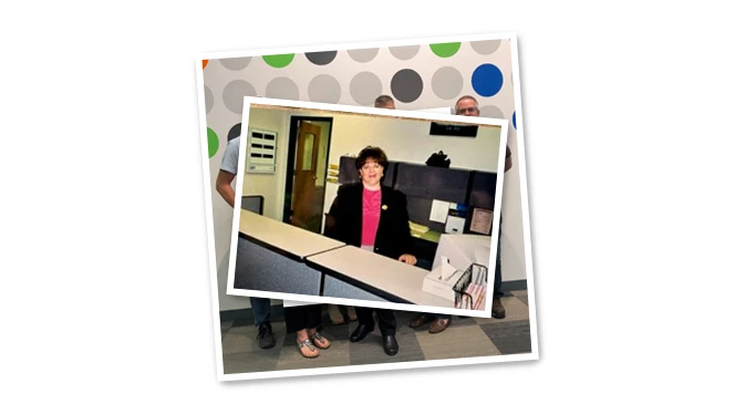 Mary McAlvey sitting at a desk. Mary McAlvey sitting at a desk.