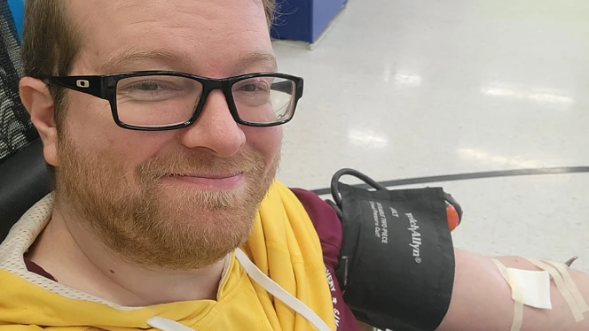 Pathway staff member donating blood