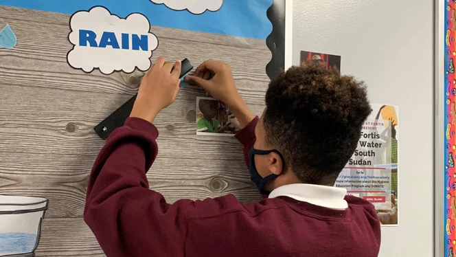 student working on bulletin board