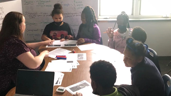 Kim Brisson works with students