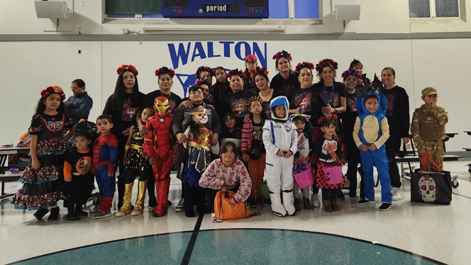 Adults and students dressed up.