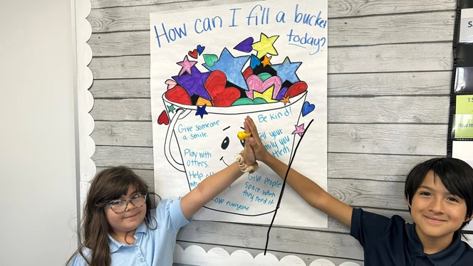 Students in front of bucket.
