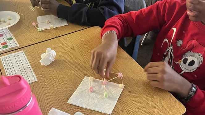 K-8 School in Detroit: Detroit Merit student works on their snowflake design.