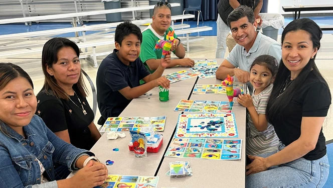 Family playing games at a table.