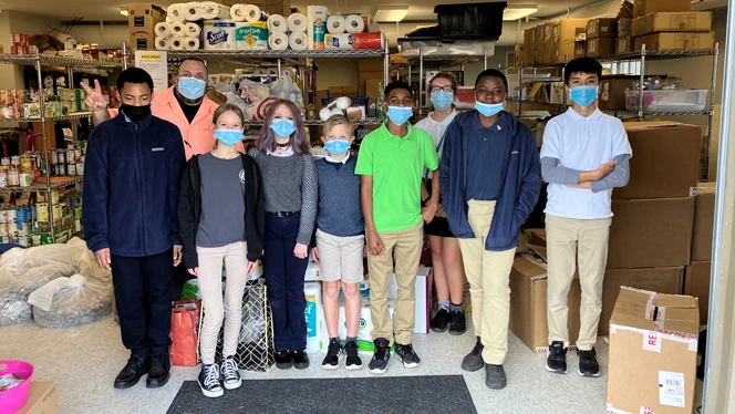 Children standing next to donations. Children standing next to donations.