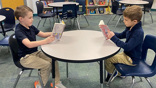 K-8 School in Jackson: Students reading at a table.