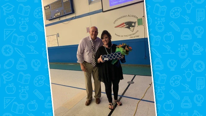 Hower smiling with a woman holding a box.