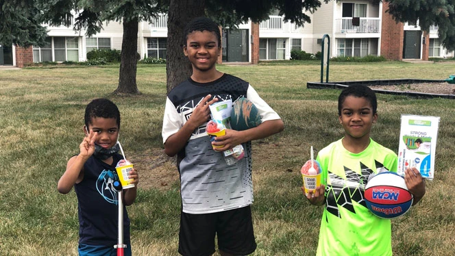 Students enjoying snow cones and smiling