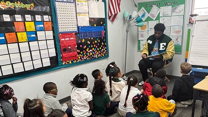 K-8 School in Ypsilanti: EMU football players visited East Arbor students.