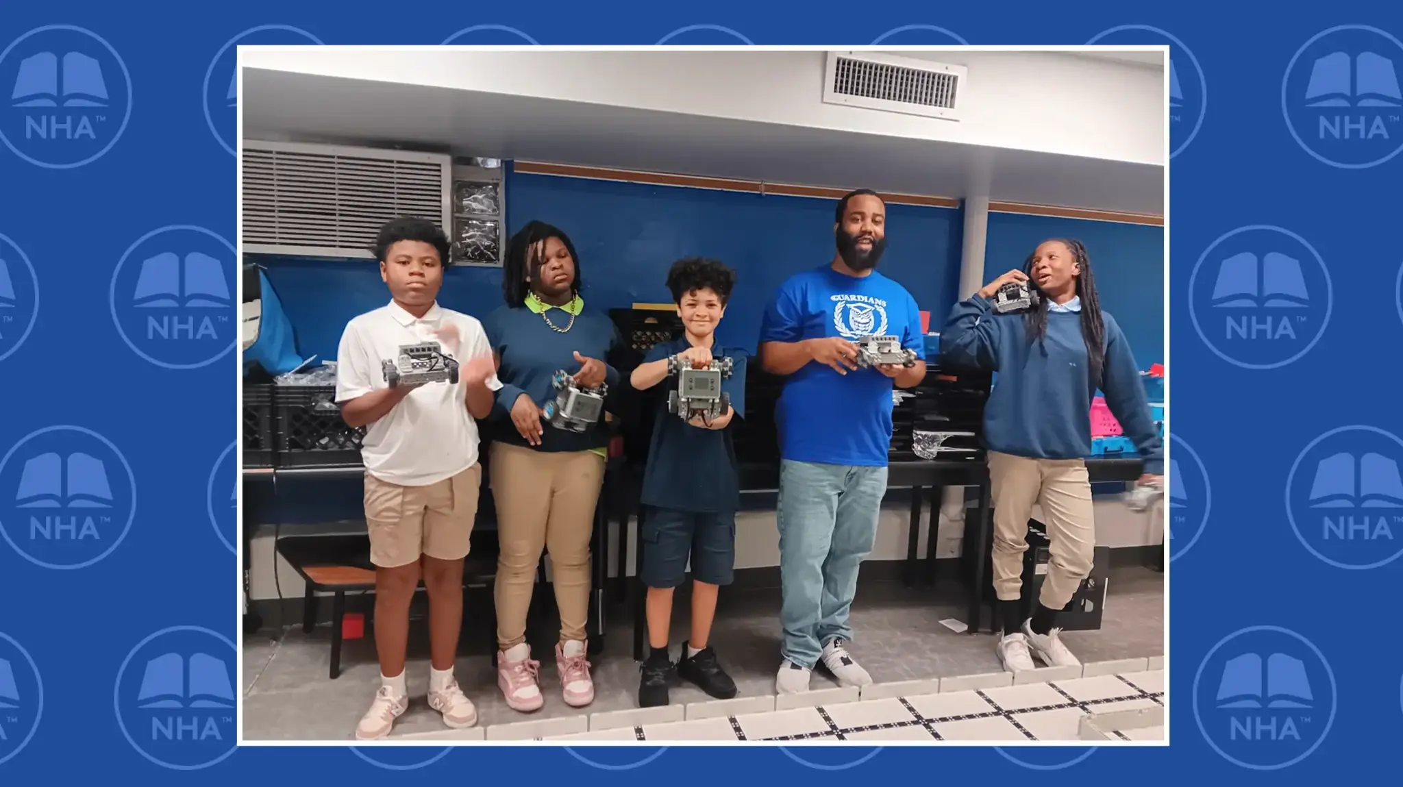 a group of people holding small robots