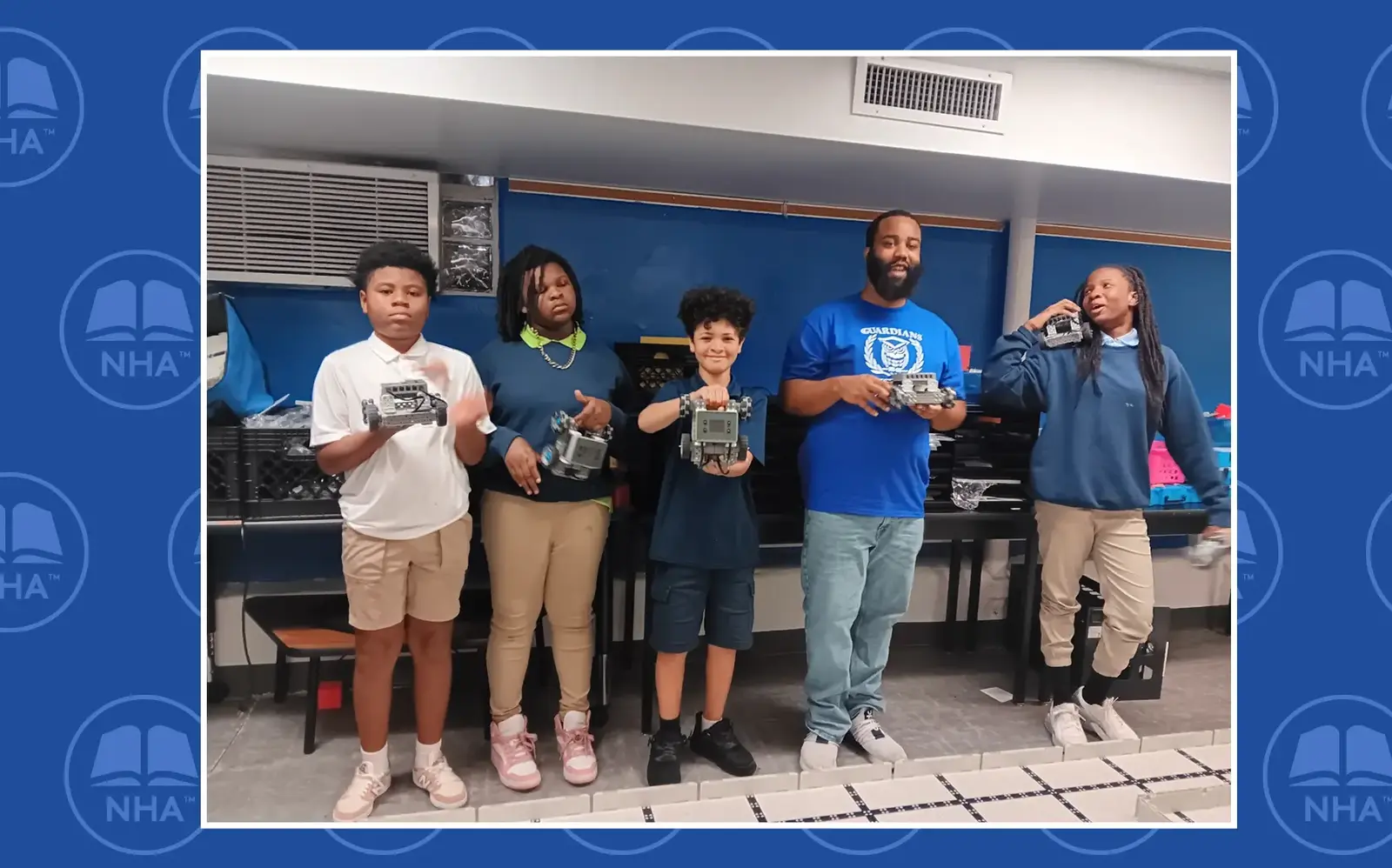 a group of people holding small robots