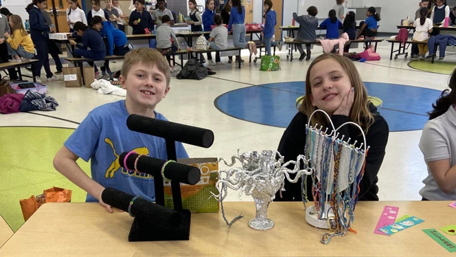 Two students are set up at their shops for Market Day