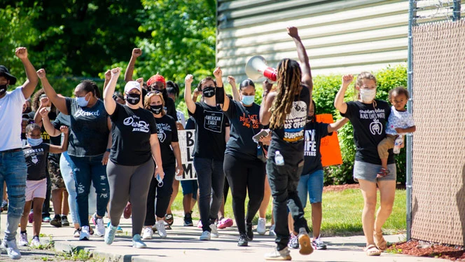 People outside with their fists in the air. People outside with their fists in the air.