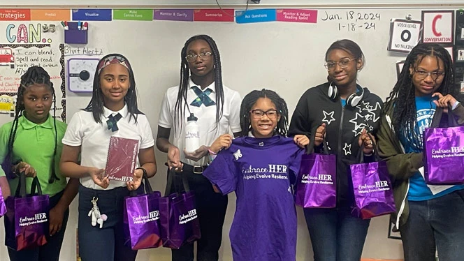 Students with "Embrace HER" swag.