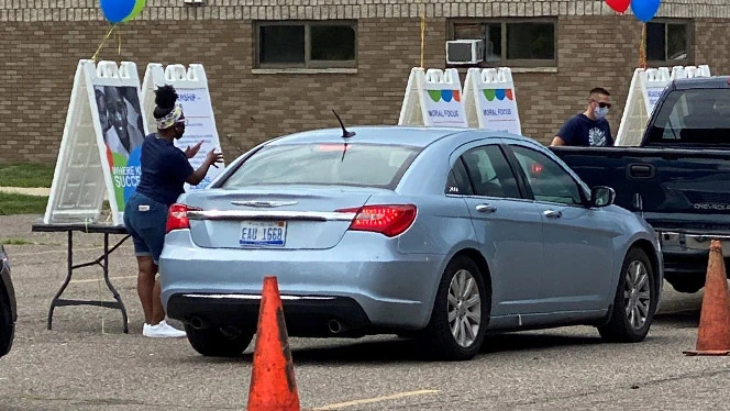 Staff helping parent register at Center Line Prep