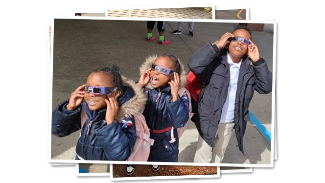 Metro students wearing eclipse glasses.