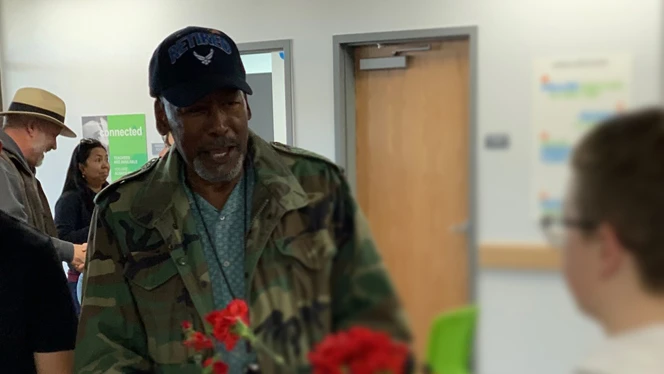 Veterans receiving carnations.