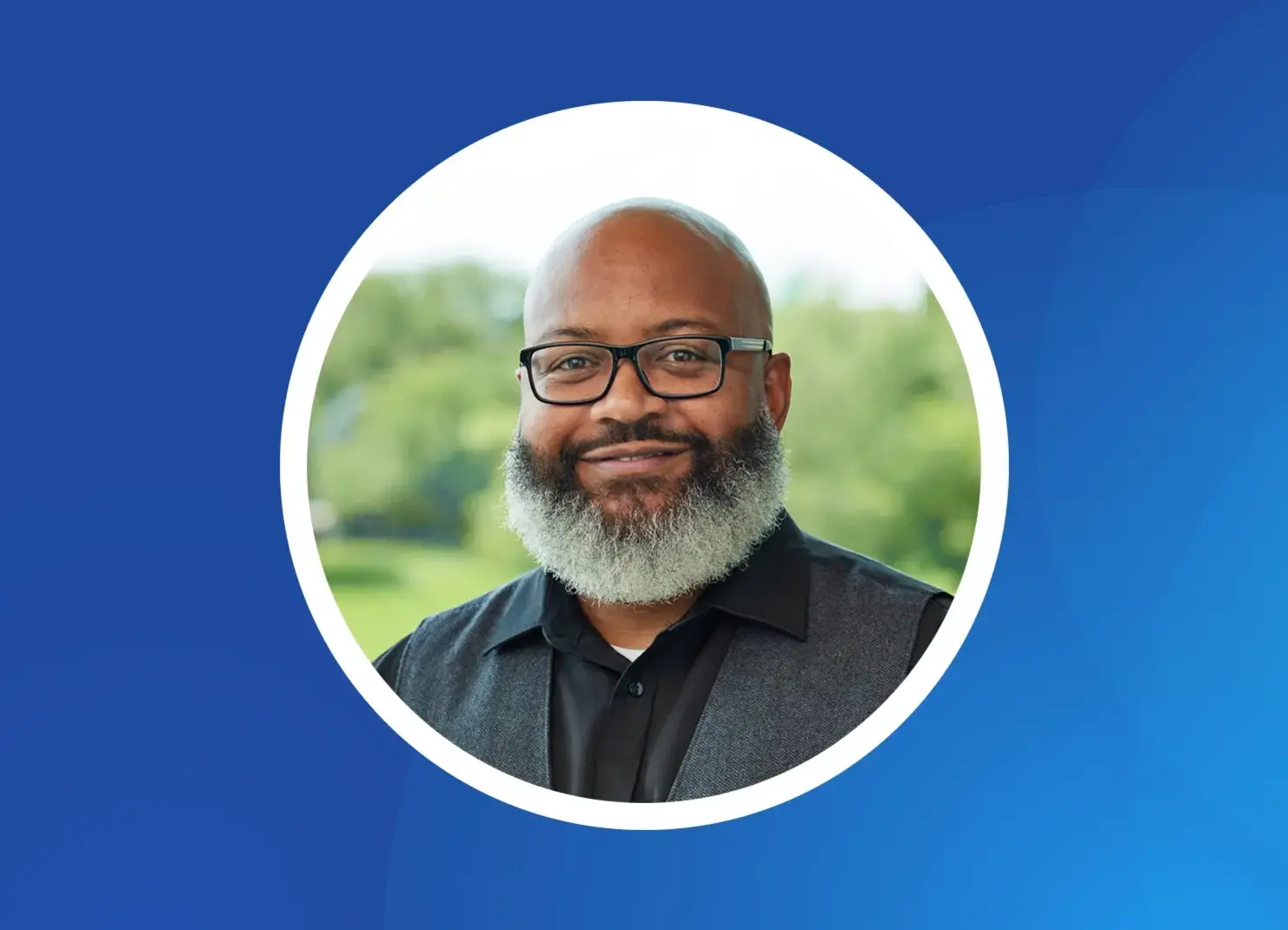 a man with a beard smiling