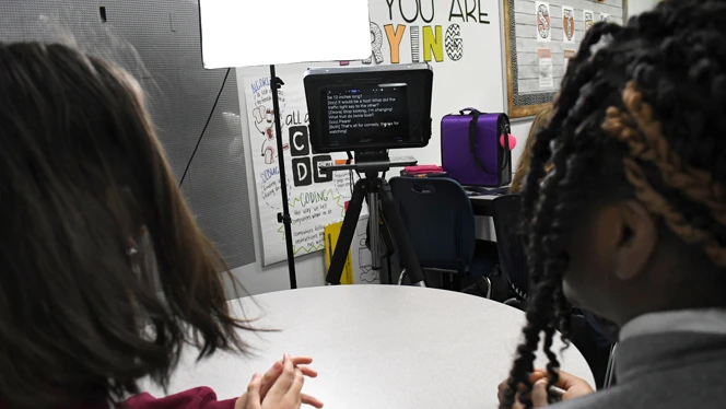 Students reading from teleprompter. Students reading from teleprompter.