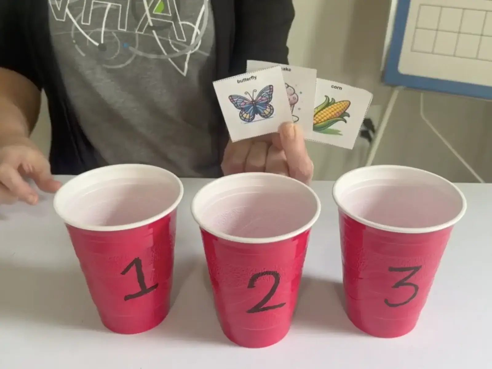 Three red cups with numbers 1, 2, 3.